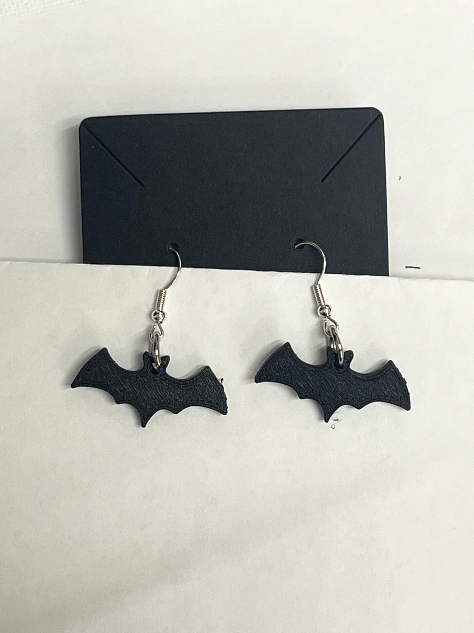 Stylish bat earrings hanging on a display
